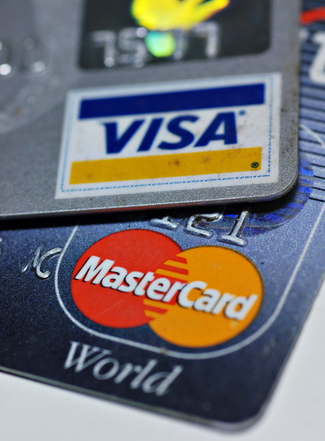 Mastercard and Visa logos are pictured on credit cards in New York.    Bloomberg