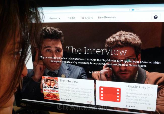 A woman looks at the Google Play purchase page for the Sony film "The Interview," in Washington on Dec. 24. (AFP-Yonhap)