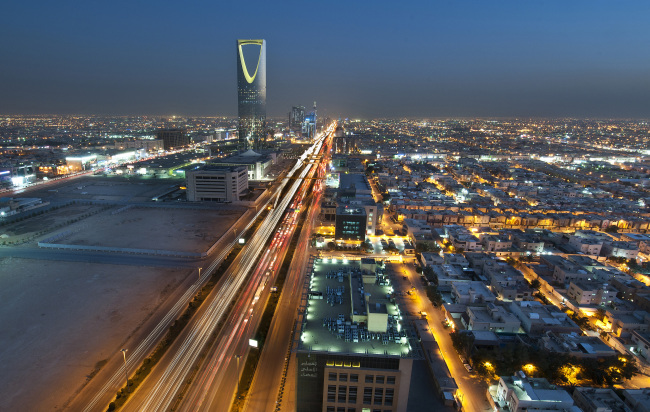 The Kingdom Tower stands illuminated at night on King Fahad Road in Riyadh, Saudi Arabia.   Bloomberg