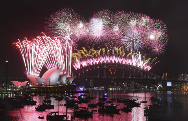 Fireworks explode over the Opera House and the Harbour Bridge during New Year’s Eve celebrations in Sydney, Australia, Thursday.   AP-Yonhap