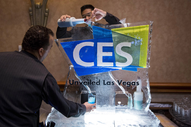 Workers pour a blue vodka-based drink through a CES-branded ice luge during the CES Unveiled press event ahead of the 2015 Consumer Electronics Show in Las Vegas, Nevada, U.S., on Sunday