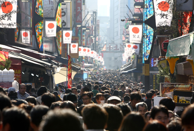 Shoppers walk through the Ameya Yokocho shopping district of Tokyo.   Bloomberg