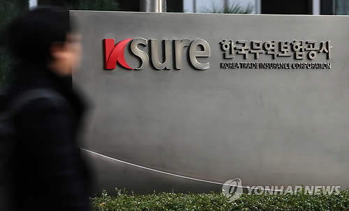 A pedestrian walks past the headquarters of K-sure in Seoul.   Yonhap
