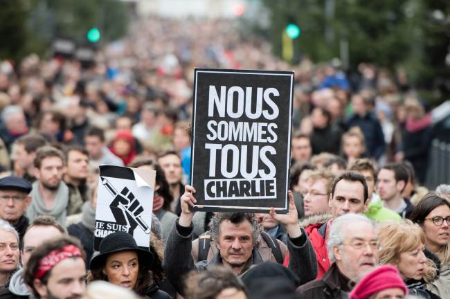A man holds a sign reading “We all are Charlie” in Lille, northern France, as tens of thousands of people staged rallies across the country following three days of terror and twin siege dramas that claimed 17 lives in total, including the victims of the first attack by armed gunmen on the offices of French satirical newspaper Charlie Hebdo in Paris on Wednesday.   AFP-Yonhap