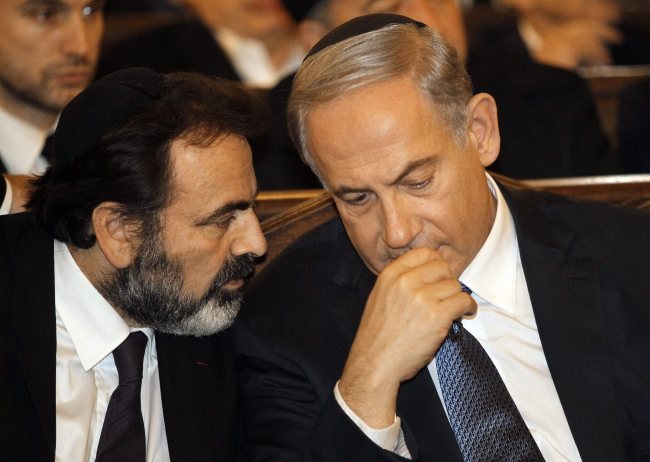 epa04555959 Israel's Prime Minister Benjamin Netanyahu (R) talks with the President of the Central Jewish Consistory of France, Joel Mergui (L) during a ceremony for the victims of the attacks in Paris this week, which claimed 17 lives, at the Grand Synagogue in Paris, France, 11 January 2015. At least 3.7 million people marched against extremism across France, according to the interior ministry, in the biggest mobilisation ever recorded in the country after the Islamist attacks that killed 17 and shocked France. Three days of terror that ended on 10 January saw 17 people killed in attacks that began with gunmen invading French satirical magazine Charlie Hebdo and continued with the shooting of a policewoman and the siege of a Jewish supermarket. EPA/MATTHIEU ALEXANDRE/POOL MAXPPP OUT