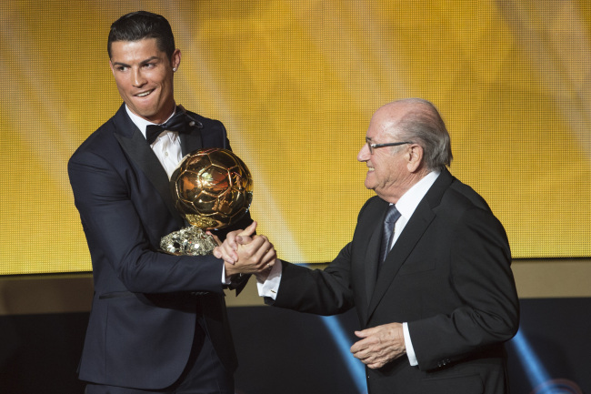 Cristiano Ronaldo (left) is congratulated by FIFA president Sepp Blatter after winning the FIFA Player of the Year award.   AP-Yonhap
