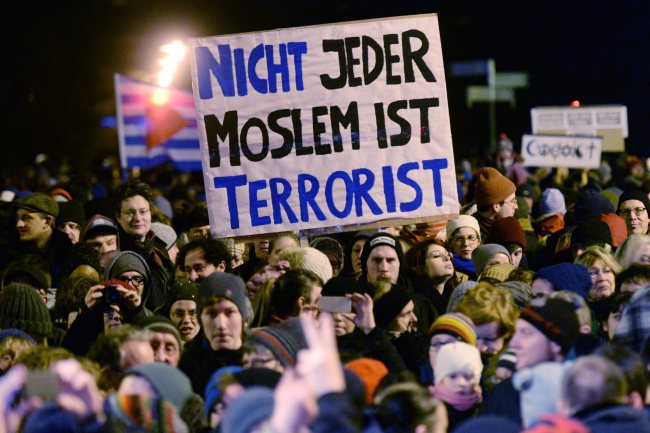 Participants in a demonstration against the anti-Islamic Legida (Leipzig against the Islamization of the West) movement hold up a sign that reads “Not every Muslim is a terrorist” in Leipzig, Germany, Monday.   EPA-Yonhap