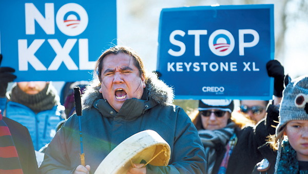 Clayton Thomas-Muller, with Idle No More and 350.org, rallies with demonstrators against the Keystone XL pipeline outside of the White House in Washington, D.C. on Saturday. (Bloomberg)