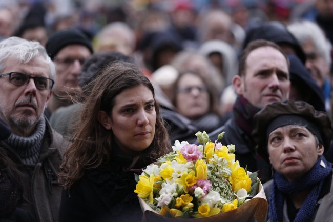People gather outside the city hall during the funeral service of late French caricaturist of satirical newspaper Charlie Hebdo, Bernard Verlhac, aka Tignous, in Montreuil, France, Thursday. EPA-Yonhap