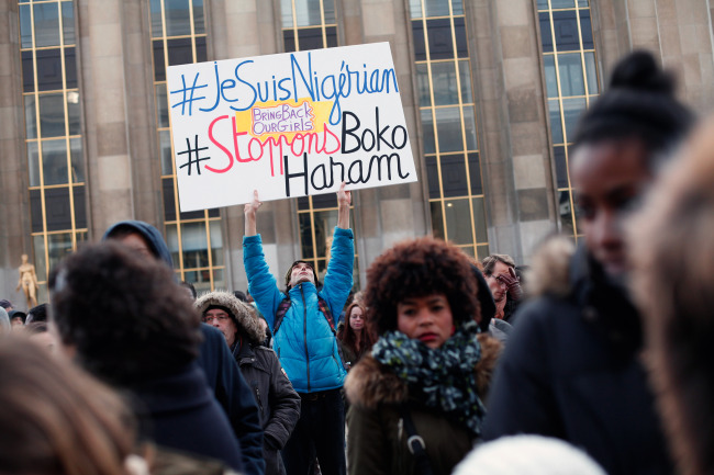 A man holds a placard reading “I am Nigerian. Stop Boko Haram” during a gathering at the Trocadero place, in Paris, Sunday, to protest against extremist Islamic group Boko Haram after a large-scale attack in Baga, where as many as 2,000 people were massacred in a raid on Jan. 7. Cameroon, Chad and Niger have launched a regional bid to combat the Boko Haram. (Related Story on Page 5)   AP-Yonhap