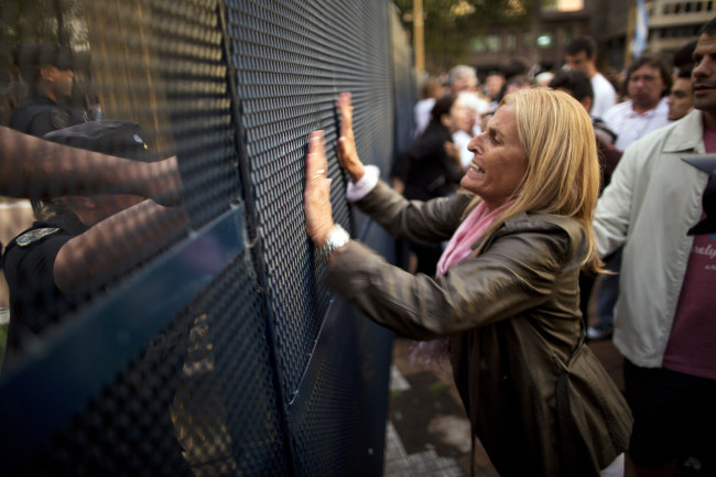 A protester shouts at police guarding the government house after the death of special prosecutor Alberto Nisman in Plaza de Mayo in Buenos Aires, Argentina, Monday. AP-Yonhap