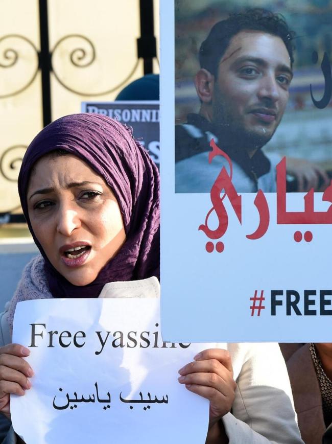 Tunisian protestors shout slogans in front of the military tribunal in Tunis during the trial for blogger and journalist Yassine Ayari on Tuesday.   AFP