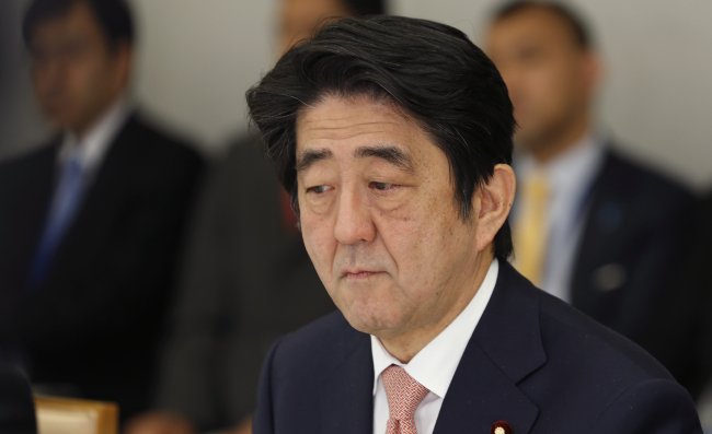 Japan’s Prime Minister Shinzo Abe reacts at a meeting on two Japanese hostages taken by the Islamic State group, at the prime minister’s official residence in Tokyo on Wednesday.   AP-Yonhap