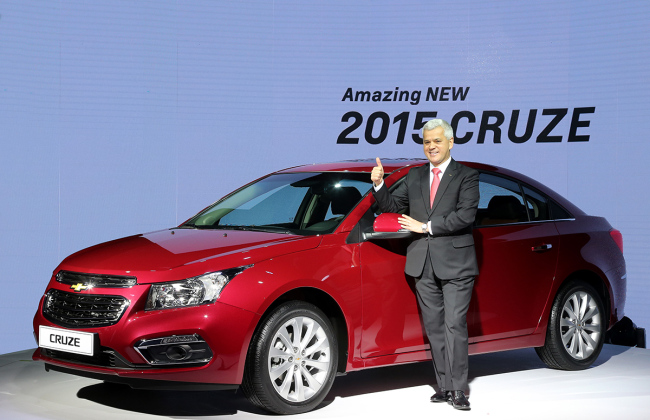 Sergio Rocha, president and CEO of GM Korea, poses in front of the “Amazing New 2015 Cruze,” which presents an updated exterior on the best-selling Chevrolet car line. The car began preorders Thursday before its sale in February. GM Korea