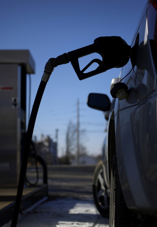 A gasoline pump nozzle in a vehicle at a gas station in Bagdad, Kentucky.  Bloomberg