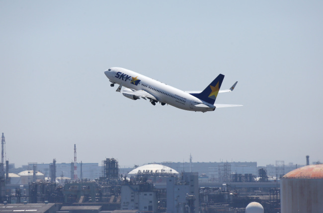 A Skymark Airlines aircraft takes off at Haneda Airport in Tokyo.   Bloomberg