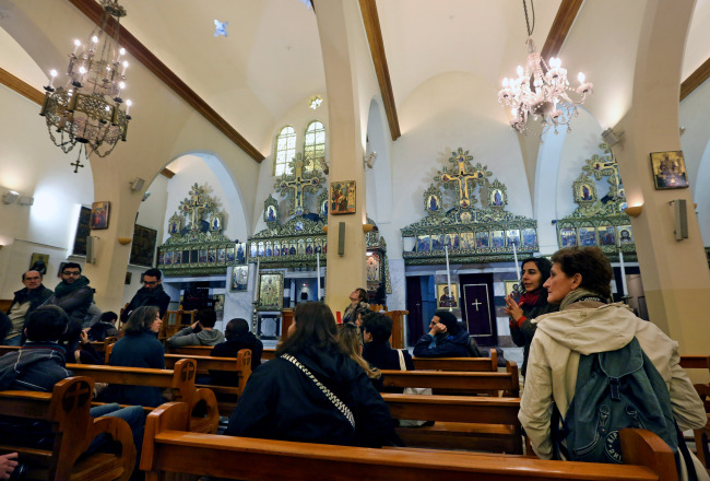 In this photo, tour guide Mira Minkara (second right) talks about the history of the St. George Greek Orthodox Church, during a day trip in the northern city of
Tripoli, Lebanon. (AP-Yonhap)