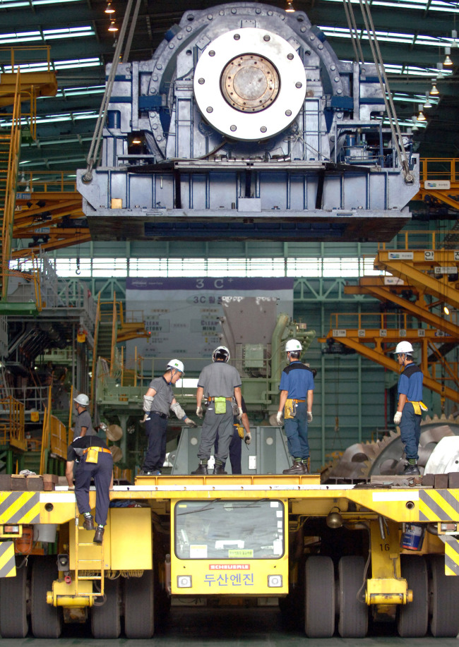Employees work at the Doosan Engine plant in Changwon, South Gyeongsang Province.  Bloomberg