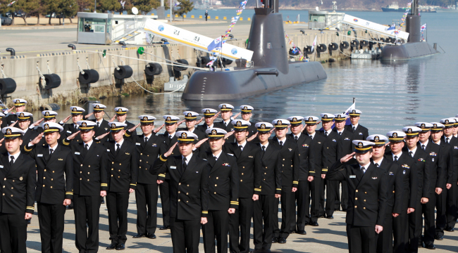 Navy service members salute during a ceremony launching the Submarine Force Command in Jinhae, South Gyeongsang Province, Monday.   Yonhap