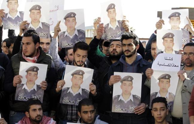Activists carry posters with a portrait of the Jordanian pilot Maaz al-Kassasbeh.   AFP