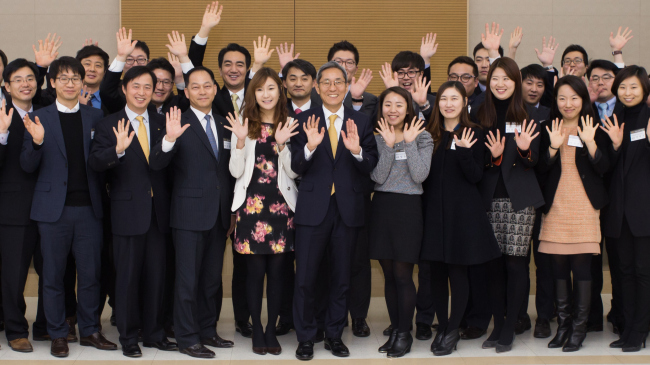 KB Financial Group employees pose together with chairman Yoon Jong-kyu (center).   KB Financial