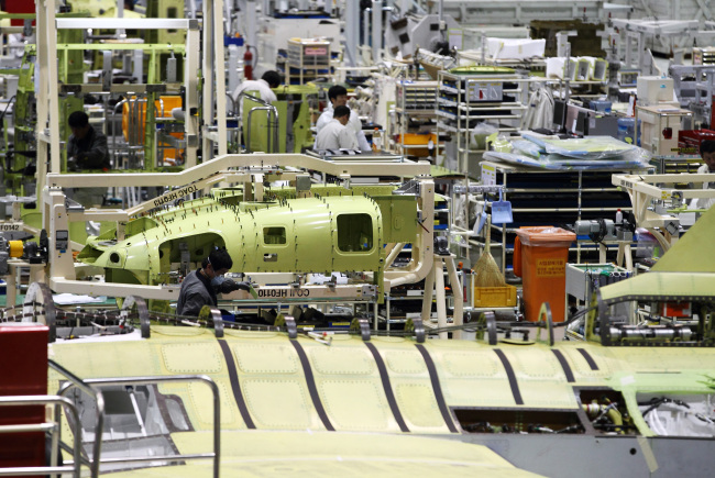 Employees work on the production line of the Korea Aerospace Industries’ plant in Sacheon, South Gyeongsang Province.   Bloomberg