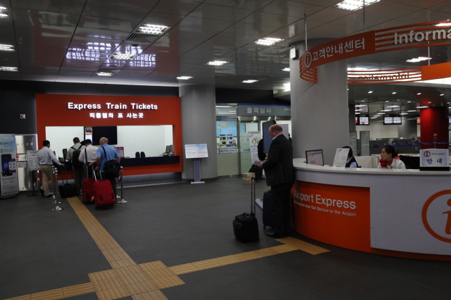 Passengers stand in line for Incheon Airport Railroad Express tickets at the Korea City Air Terminal, located at Seoul Station.   IAR