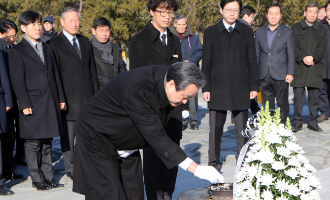 The ruling Saenuri Party chairman Koo Moo-sung pays respect to the late President Roh Moo-hyun at his tomb in Gimhae, South Gyeongsang Province, on Saturday. Kim praised Roh's “endeavors to cease turf wars and authoritarianism in the country” and said he hopes to bring harmony and reconciliation in the political scene through his visit. Kim is the second Saenuri Party leader to visit Roh's tomb, following former chairman Hwang Woo-yea in 2011. (Yonhap)