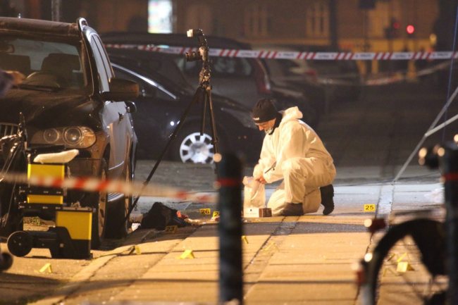 A forensic expert investigates the scene in front of Krudttoenden cafe, where shots were reportedly fired during a discussion meeting about art, blasphemy and free speech in Copenhagen, Denmark, Saturday.    (EPA-Yonhap)
