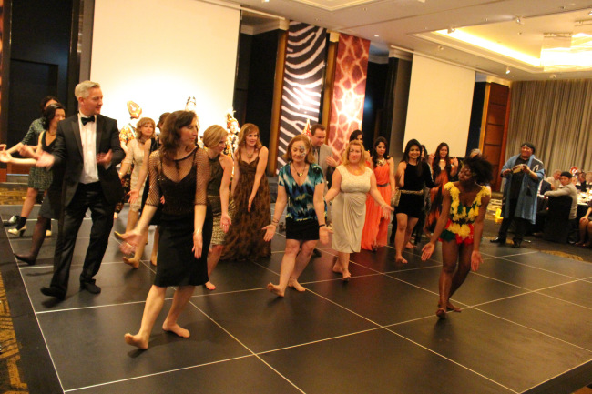 A dancer leads attendees of last year’s safari-themed SIWA Gala in some traditional African dance.   Mhyla Borkowski