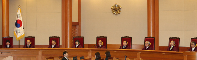 Nine judges deliver a decision at the Constitutional Court in Seoul on Thursday.   Yonhap