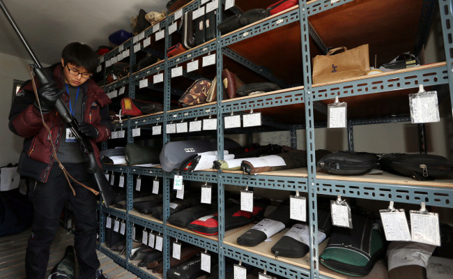 A police officer inspects a gun at an armory in Yeonsu Police Station in Incheon on Friday.   Yonhap