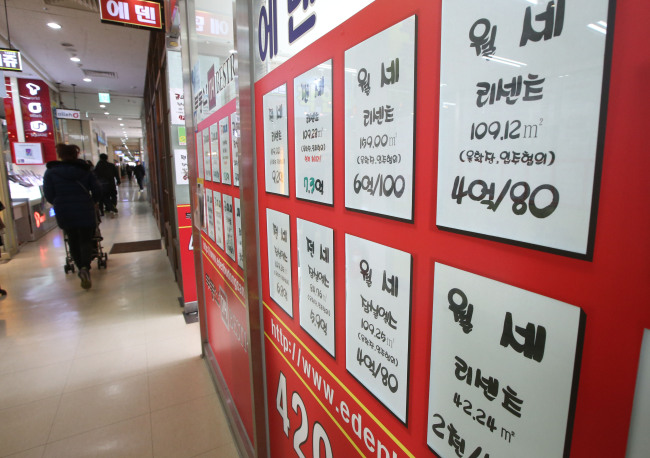 A real estate agency posts apartment rent price tags in its window.  Yonhap