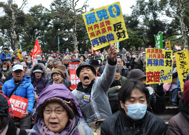 People hold placards to protest against nuclear power in Tokyo on Monday.   Xinhua-Yonhap