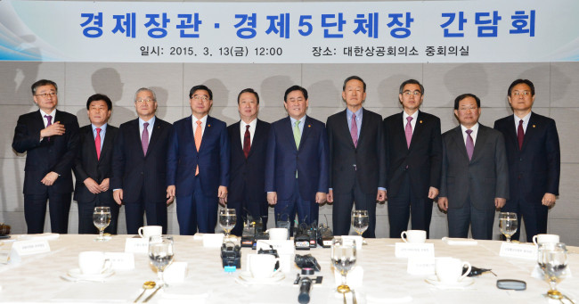 Finance Minister Choi Kyung-hwan (fifth from right) poses for a photo with the heads of Korean business associations and officials of government agencies ahead of a meeting to discuss ways to revive the economy in Seoul on Friday.   Finance Ministry