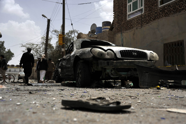 A damaged car and a shoe of a victim are seen in Sanaa, Yemen, Saturday.   Xinhua-Yonhap