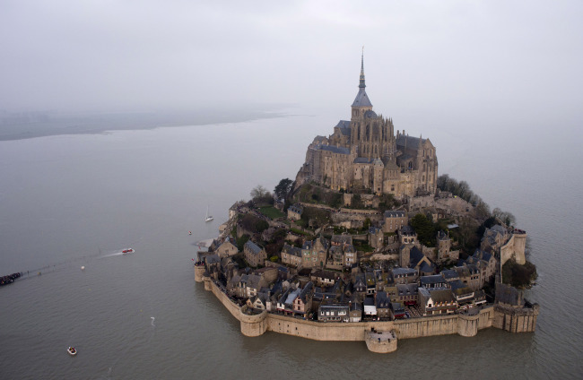 An aerial view as a high tide submerges a narrow causeway leading to the Mont Saint-Michel, on France's northern coast, Saturday. AP