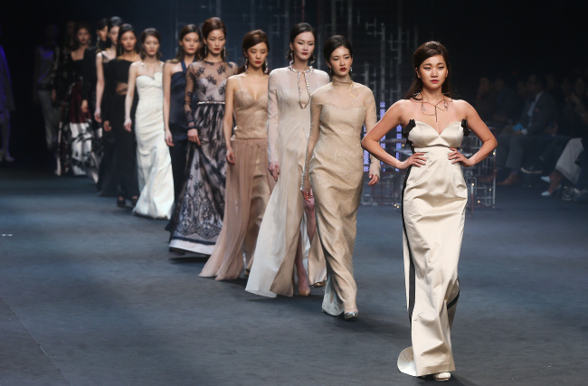 Models present creations by designer Gee Choon-hee of Miss Gee Collection during the Seoul Fashion Week at Dongdaemun Design Plaza in Seoul on Monday.    Yonhap