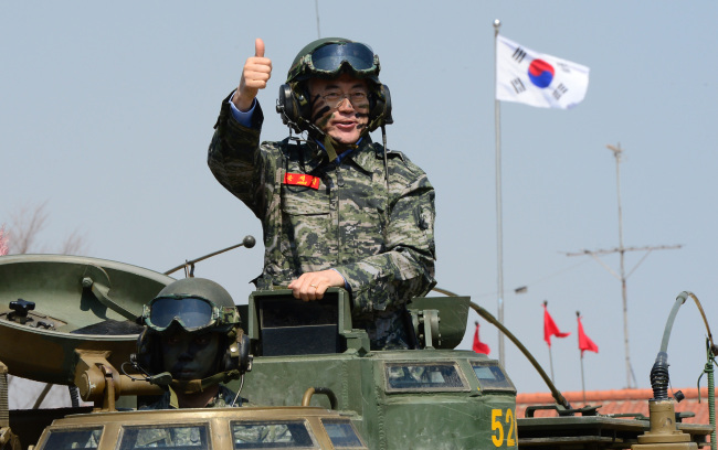 New Politics Alliance for Democracy leader Rep. Moon Jae-in takes a ride on an amphibious armored vehicle during his visit to the 2nd Marine Division at Gimpo, Gyeonggi Province, Wednesday.   Yonhap