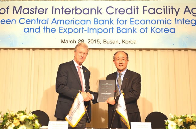 Lee Duk-hoon (right), president of state-run Export-Import Bank of Korea, poses after signing a $100 million credit facility agreement with Nick Rischbieth, executive president of the Central American Bank for Economic Integration on Saturday.   Korea Eximbank