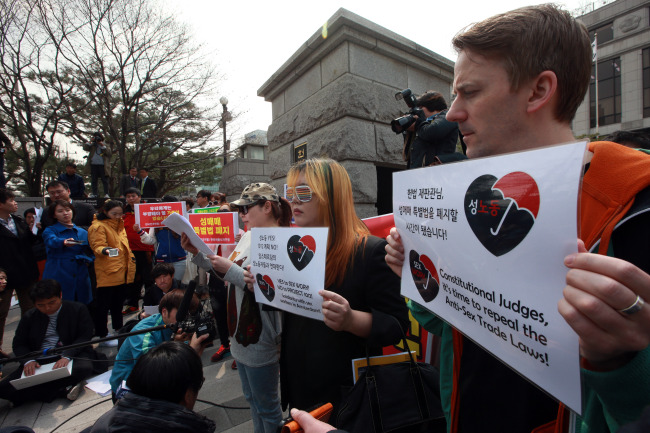 Activists hold a rally to demand a repeal of the anti-sex trade law in front of the Constitutional Court on Thursday.   Yonhap
