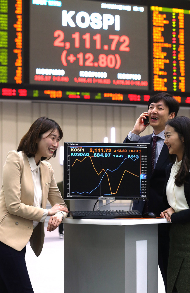 An electronic board at Korea Exchange shows the KOSPI surpassing the 2,100 barrier for the first time nearly in four years on Tuesday. Yonhap