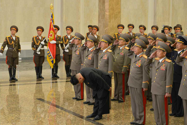 North Korean leader Kim Jong-un (front) pays his respects to his late grandfather, national founder Kim Il-sung, at the Kumsusan Palace of the Sun in Pyongyang on Wednesday.   Yonhap