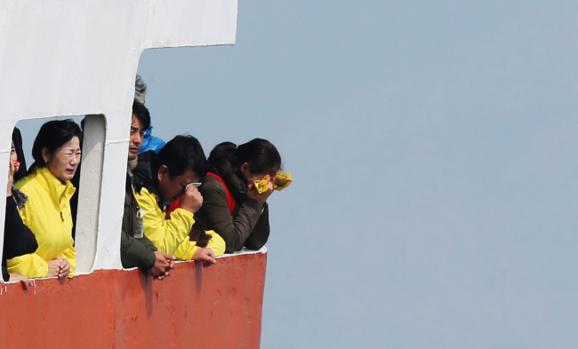 Families of Sewol disaster victims weep as they offer flowers to the waters off Jindo, South Jeolla Province, Wednesday.    Yonhap
