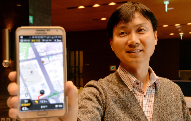 Loc & All CEO Park Jong-hwan poses with the company’s Kimgisa app on Tuesday at a Seoul hotel. (Ahn Hoon/The Korea Herald)