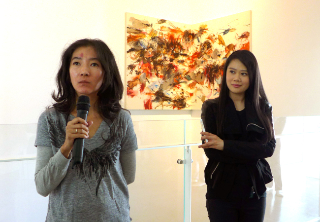 (from left) Artist Christine Tjoe and curator Jasmine Prasetio speak to journalists at the exhibition, “Perfect Imperfection,” at the SongEun Art Space gallery in Seoul on Tuesday.