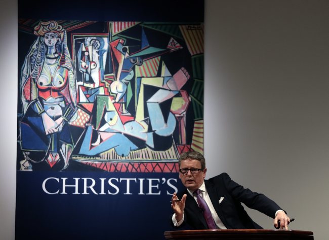 Auctioneer and global president of Christie’s Jussi Pylkkaenen auctions off Pablo Picasso’s painting “The Women of Algiers (Version ‘O’),” oil on canvas, during an auction at Christie’s in New York on Monday.   EPA-Yonhap