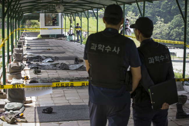 Officials from the National Forensic Service inspect Thursday a military training camp in Seoul, where a reserve soldier went on a shooting rampage that left three dead ― including the shooter himself ― and two others injured.   Yonhap