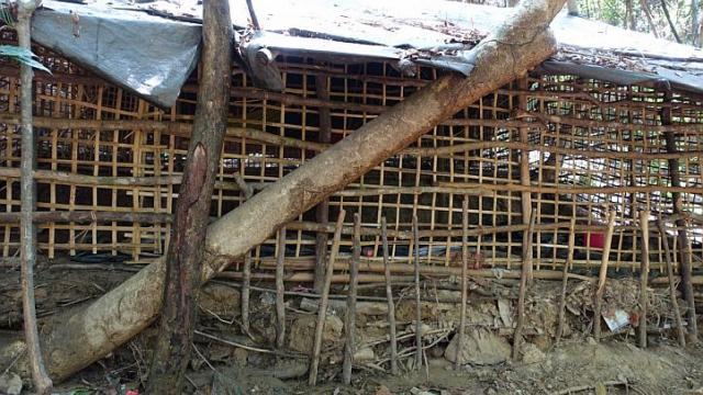 A bamboo prison and a child’s shirt found at the abandoned human traffickers’ camp near Ban Taloh village in Padang Besar. When security officers entered the camp, they found shallow graves containing at least 26 bodies.   The Straits Times