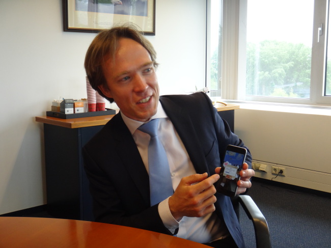 Tjalling Smit, senior vice president of e-commerce at Air France KLM, shows the company’s new mobile game, “Jets ― Flying Adventure,” on his smartphone at KLM’s headquarters in Amsterdam, the Netherlands.   KLM